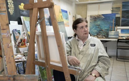 Retired translator Ute Rebholz paints a canvas.