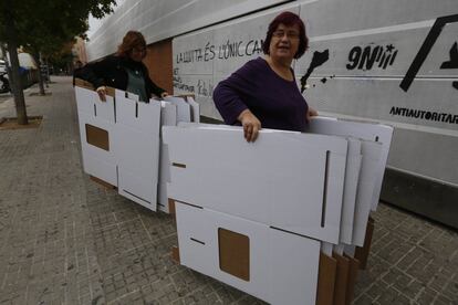 Unos voluntarios llevan urnas al Instituto Montserrat Roig donde se podrá votar el 9-N en Terrasa, Barcelona.