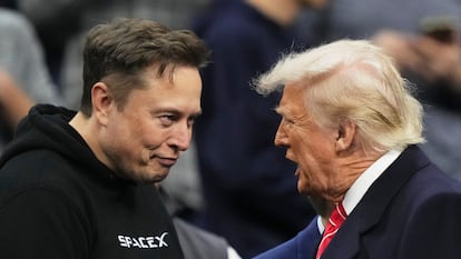FILE - Elon Musk, left, shakes hands with President Donald Trump at the finals for the NCAA wrestling championship, March 22, 2025, in Philadelphia. (AP Photo/Matt Rourke, File)