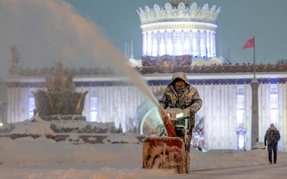 A municipal worker clears snow in Moscow last December.