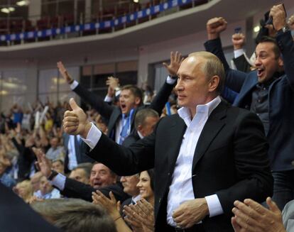 Russian President Vladimir Putin, foreground right, gestures, as he attends the Judo World Cup in the city of Chelyabinsk in Siberia, Russia, on Sunday, Aug. 31, 2014. Putin is calling on Ukraine to immediately start talks on a political solution to the crisis in eastern Ukraine, including discussing statehood. (AP Photo/ Alexei Druzhinin, Presidential Press Service)
