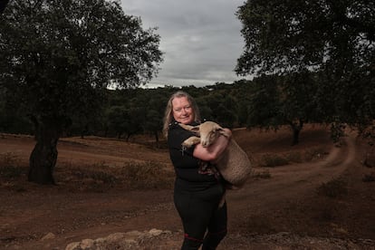 Ernestine Lüdeke holds a sheep on her farm in Santa Olalla del Cala (Huelva). 