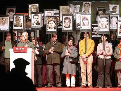 Miembros y simpatizantes de ANV, con fotos de presos etarras, durante el acto de ayer en Vitoria.