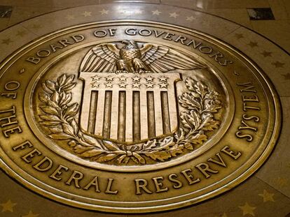 FILE- In this Feb. 5, 2018, file photo, the seal of the Board of Governors of the United States Federal Reserve System is displayed in the ground at the Marriner S. Eccles Federal Reserve Board Building in Washington. Federal Reserve Governor Michelle Bowman said Monday, Feb. 21, 2022, that she was open to lifting interest rates by more than the traditional quarter-point at the central bank's next meeting in March. (AP Photo/Andrew Harnik, File)