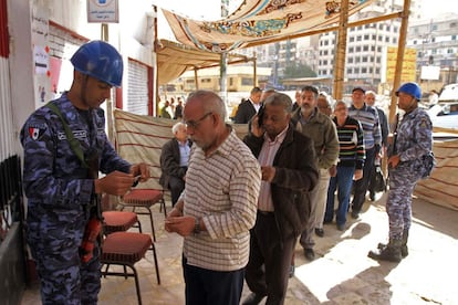 Um militar egípcio comprova as identificações dos eleitores em um centro eleitoral do Cairo.