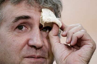 El paleontólogo Juan Luis Arsuaga muestra una parte de un cráneo fechado hace 500.000 años y encontrados en Atapuerca.