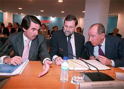 Aznar conversa con Rajoy y Rato antes de comenzar la reunión de la Junta Directiva Nacional del PP.