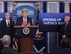 President Donald Trump answers questions as Vice President Mike Pence and Dr. Anthony Fauci listen during an announcement of the Trump administration's guidelines for "Opening Up America Again" at the daily coronavirus task force briefing at the White House in Washington, U.S., April 16, 2020. REUTERS/Leah Millis