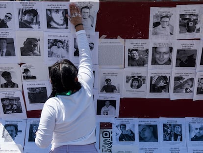 Una activista coloca imágenes de agresores sexuales durante una protesta en el Zócalo capitalino, el 8 de marzo de 2022.