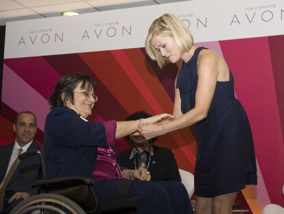 La actriz Reese Witherspoon entrega un reconocimiento a Maria da Penha, en São Paulo, durante una visita a Brasil en 2008 como embajadora de Avon para impulsar el empoderamiento femenino. 