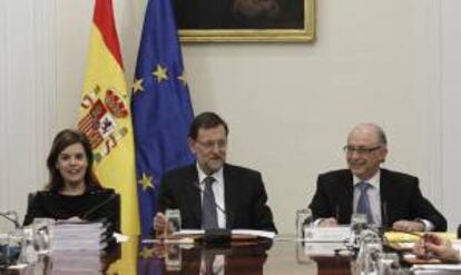 El jefe del Gobierno, Mariano Rajoy (c), el ministro de Hacienda y Administraciones Públicas, Cristóbal Montoro (d), y la vicepresidenta del Ejecutivo, Soraya Sáenz de Santamaría (i), durante la reunión de la Comisión para la Reforma de las Administraciones Públicas, que se ha celebrado hoy en el Palacio de la Moncloa de Madrid.