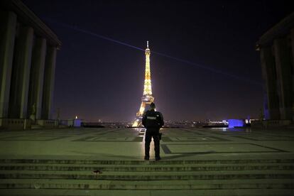 Policial patrulha a praça Trocadero em Paris. Ao fundo, a Torre Eiffel.