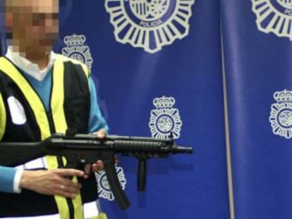 Un polic&iacute;a muestra las armas intervenidas a los secuestradores de dos hombres en Sevilla.
