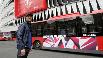 Ismael Iglesias, ante el estadio de San Mamés por donde pasa uno de los autobuses decorados para la final.