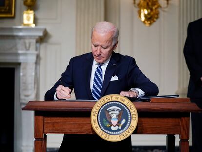 FILE - In this Jan. 27, 2021 file photo, President Joe Biden signs an executive order on climate change, in the State Dining Room of the White House in Washington. Biden is convening a coalition of the willing, the unwilling, the desperate-for-help and the avid-for-money for a two-day summit aimed at rallying the world’s worst polluters to do more to slow climate change. Biden’s first task when his virtual summit opens Thursday is to convince the world that the United States is both willing and able isn’t just willing to meet an ambitious new emissions-cutting pledge, but also able.  (AP Photo/Evan Vucci)