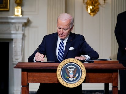 FILE - In this Jan. 27, 2021 file photo, President Joe Biden signs an executive order on climate change, in the State Dining Room of the White House in Washington. Biden is convening a coalition of the willing, the unwilling, the desperate-for-help and the avid-for-money for a two-day summit aimed at rallying the world’s worst polluters to do more to slow climate change. Biden’s first task when his virtual summit opens Thursday is to convince the world that the United States is both willing and able isn’t just willing to meet an ambitious new emissions-cutting pledge, but also able.  (AP Photo/Evan Vucci)