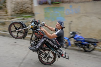 Luis Jesús Franco practices “motorcycle pirouettes” in the alleys of El Valle, in Caracas, Venezuela, in June of 2024. This activity has been decreed a national sport by President Maduro.