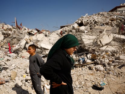 Fatmagul Arslan, 19-year-old, and her brother Saltuk, 9-year-old, stand as they visit the remains of their home, where they were trapped for five days with their parents and sister until being rescued, in the aftermath of a deadly earthquake in Nurdagi, Turkey, March 4, 2023. REUTERS/Susana Vera