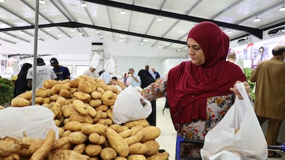 Una mujer selecciona patatas en un puesto de un mercado de Misrata (Libia), en septiembre de 2024.