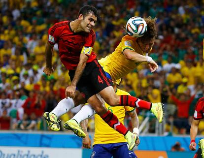 El jugador de México, Rafael Márquez (i) disputa un balón con el jugador de la selección brasileña, David Luiz durante el partido de la Copa del Mundo celebrado en Fortaleza (Brasil).