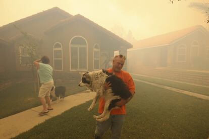 Estados Unidos divulgó este martes un ambicioso informe científico que hace sonar las alarmas sobre los efectos presentes y futuros del cambio climático en el país, un análisis lleno de pronósticos sombríos con el que la Casa Blanca quiere impulsar su agenda para reducir las emisiones de gases de efecto invernadero. En la imagen, unas personas salen de sus casas durante un incendio en Rancho Cucamonga, California, 30 de abril de 2014.