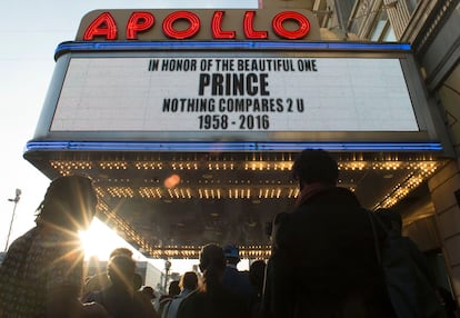 Gente se reúne en el exterior del Teatro Apollo (Nueva York) para escuchar música de Prince el 21 de abril de 2016, día de la muerte del cantante. 