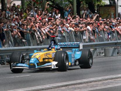 Fernando Alonso conduce por la Castellana aclamado por los aficionados.
