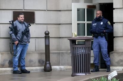 A policeman stands guard at the entrance to the state capitol during a gun rights rally, in Lansing, Michigan, in 2021.