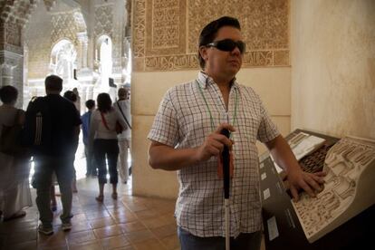 Carlos Marín runs his fingers over recreations of some of the Alhambra's patterns