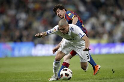 Real Madrid&#039;s Pepe tries to protect the ball under challenge from Barcelona&#039;s Leo Messi during an April, 2011 cl&aacute;sico.