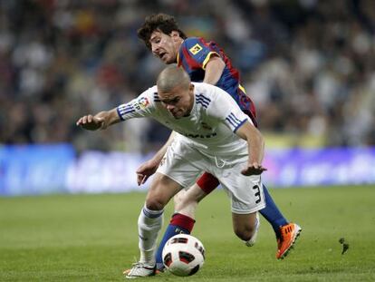 Real Madrid&#039;s Pepe tries to protect the ball under challenge from Barcelona&#039;s Leo Messi during an April, 2011 cl&aacute;sico.