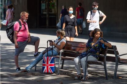 Una pareja de turistas británicos descansa en un banco de las Ramblas este lunes, un día después de que el Reino Unido anunciase que impondrá una cuarentena a los viajeros procedentes de España y después de que el primer ministro francés, Jean Castex, recomendara a sus conciudadanos no visitar Cataluña.