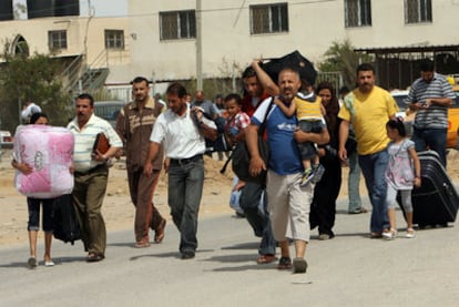 Varios palestinos se dirigen ayer al paso fronterizo de Rafah, que comunica la franja de Gaza y Egipto.