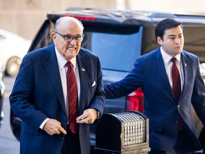 Rudy Giuliani (L) arrives to the US District Court for jury selection in his defamation case brought by two Fulton County election workers in Washington, DC, USA, December 11 2023.