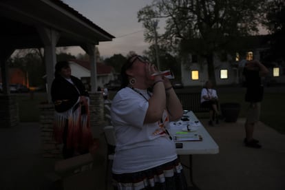 Una mujer grita como parte de una tradición de la nación Choctaw derivada de una leyenda sobre el uso de matracas para ahuyentar a la 'Fvni Lusa', o ardilla negra, para que no se coma el sol, durante el eclipse solar total en Millerton (Estados Unidos).