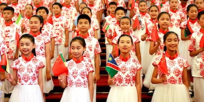 Chinese children hold flags during a rehearsal prior to the opening of the Forum on China-Africa Cooperation in Beijing on September 3, 2018. - President Xi Jinping told African leaders on September 3 that China's investments on the continent have