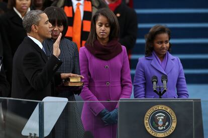 Barack jurando ante la atenta mirada de Michelle.