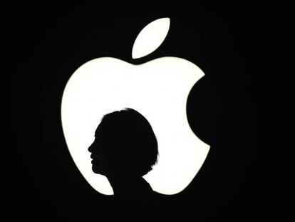 La silueta de una mujer junto a un logo de Apple en un evento en San Francisco. 