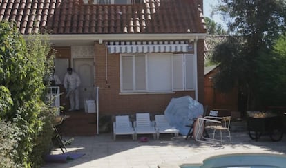 Forensic experts inspect the house where the four bodies were found.