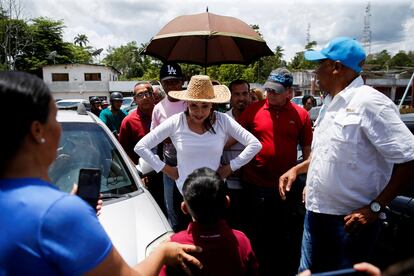 Maria Corina Machado greets a child at a rally in Caripito on March 28.