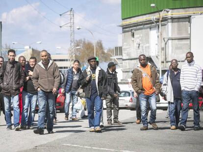 Workers at a slaughterhouse in Vic end their shift.