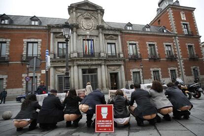 Activistas de la organización ONGAWA, Ingeniería para el Desarrollo Humano, simulan defecar al aire libre frente al Ministerio de Asuntos Exteriores y Cooperación, en Madrid, para recordar que 2.500 millones de personas en el mundo carecen de saneamiento.