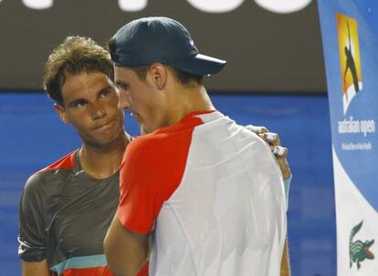 Rafael Nadal commiserates with Bernard Tomic in Melbourne.