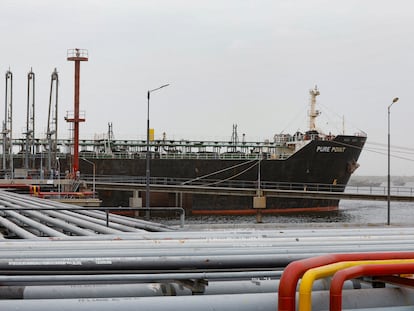 Crew members check the deck of the Russian oil cargo Pure Point