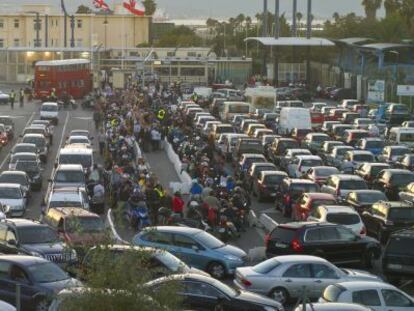 Veh&iacute;culos y peatones esperan para cruzar la verja de Gibraltar.