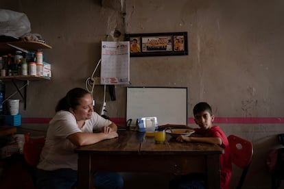 Edgar García, paciente de ataxia de 10 años, come en compañía de su mamá Librada Morales.