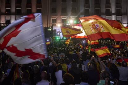 Vox supporters listen to party leader Santiago Abascal outside the Fenix Hotel in Madrid.