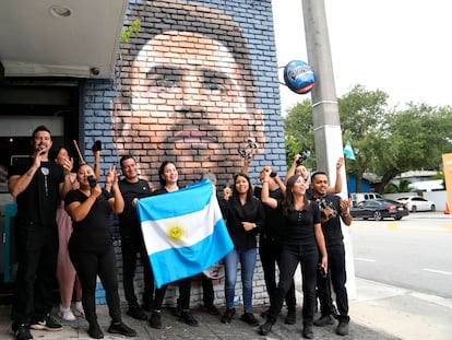 El personal del restaurante Fiorito con una bandera de Argentina frente a un mural de Lionel Messi, en Miami este miércoles.
