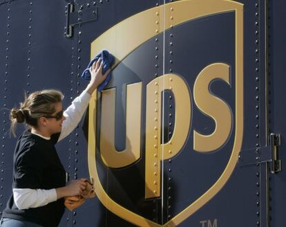 Una empleada de UPS limpia un camión de la compañía