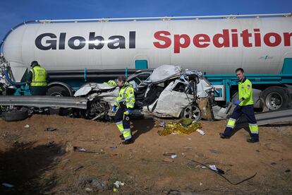 Un coche permanece aplastado entre la mediana y un camión de gran tonelaje.